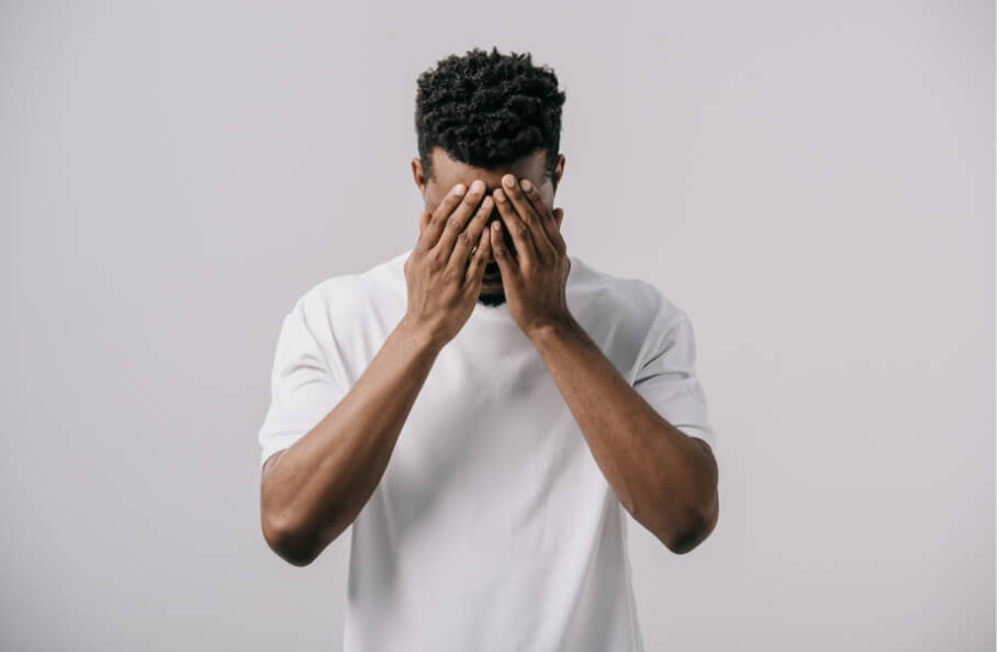 african-american-man-in-white-t-shirt-covering-fac-2023-11-27-05-24-51-utc-1