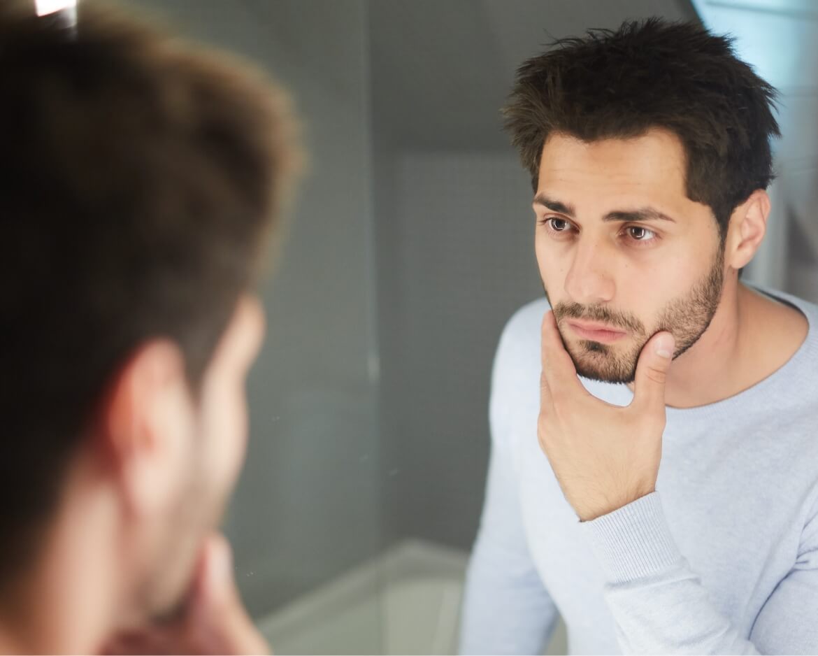handsome-man-touching-beard-and-looking-into-mirro-2025-03-15-04-22-58-utc (1)