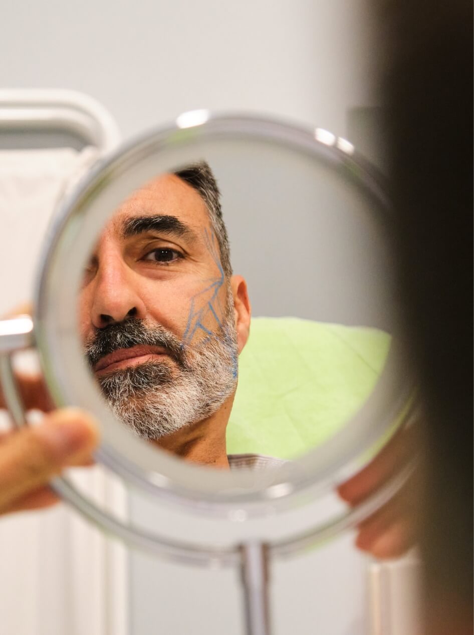 mature-caucasian-man-looking-into-the-mirror-befor-2025-03-16-19-29-46-utc (1)